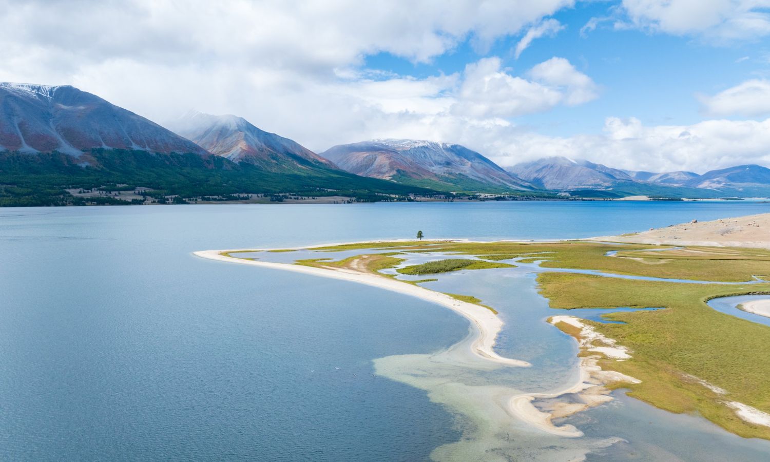 Aerial view of Khoton Lake with sandy spits and mountains in the Mongolian Altai